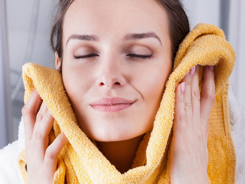 Woman enjoying the softness of a towel